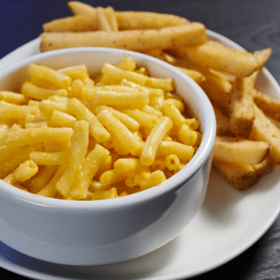 a bowl of Mac and cheese and French fries