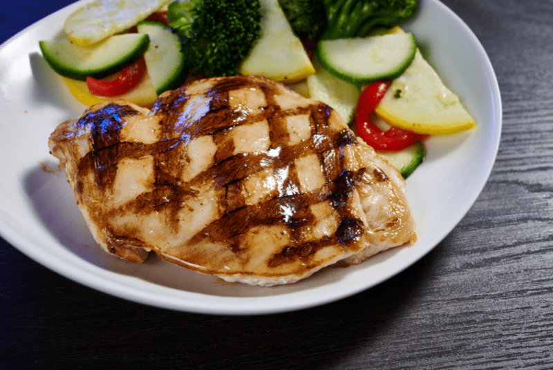 grilled chicken breast for kids with a side of veggies placed on a plate