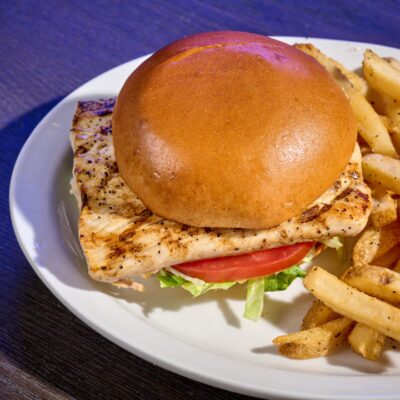 Mahi Mahi Sandwich from Miller's Ale House on a plate with Fries