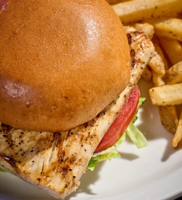 Mahi Mahi Sandwich from Miller's Ale House on a plate with Fries